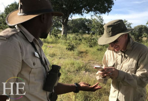 a park ranger holds a creature for a guest to photograph on the HE Travel Gay Safari in Botswana-botswana-luxury-gay-safari-HETravel-gay-tours-travel