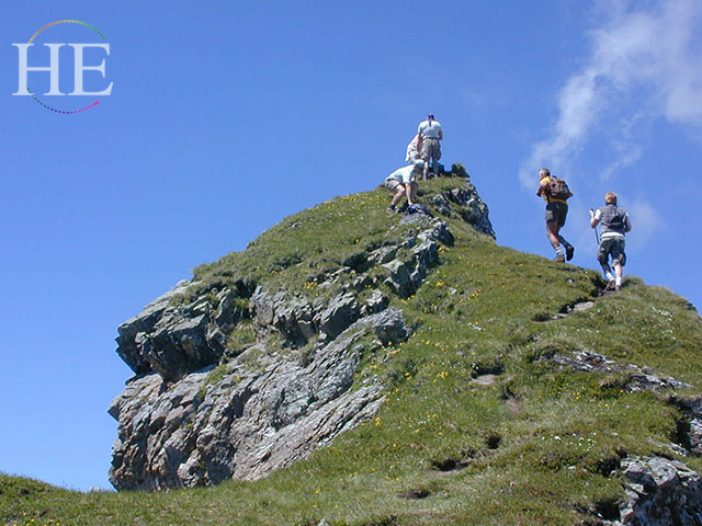 Grindelwald Gay Tour By HE Travel pictures hikers reaching the top of a mountain peak