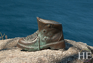 A sculpture of a hiking boot in Finisterre, Spain on HE Travel's Hiking Santiago de Compostela Tour.