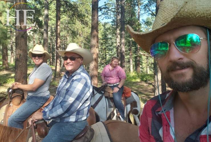 zach moses on horses with two men and one woman on horses for travel group