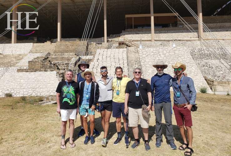 HE travel group of gay lgbtq+ men poses in front of pyramid