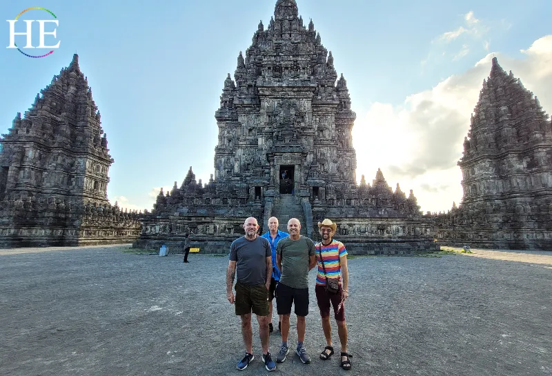 HE Travel group poses in front of Prambadan Temple, 4 guys, bright colors, cold stone