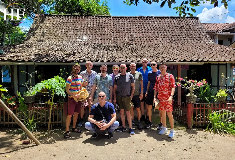 HE Travel group poses in front of house in Balinese village