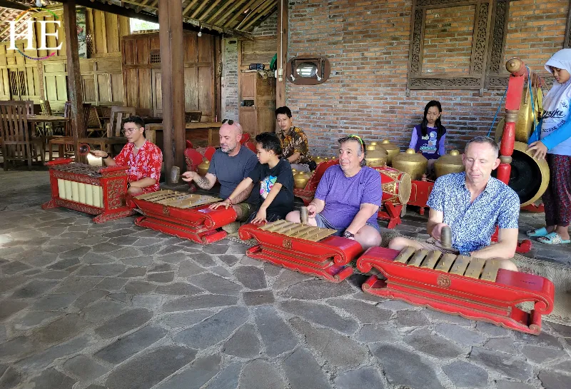 HE Travel group playing music with the locals on their xylophones 