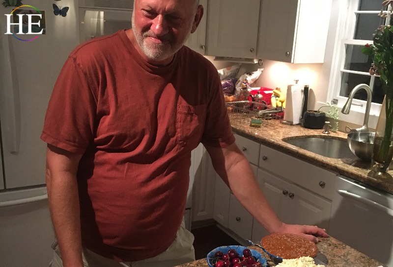 Doug Mayberry standing over a kitchen of ingredients.